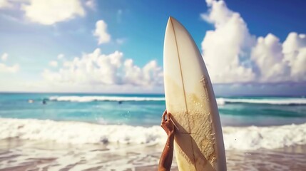 Closeup of surfer adjusting their surfboard on the beach before hitting the waves