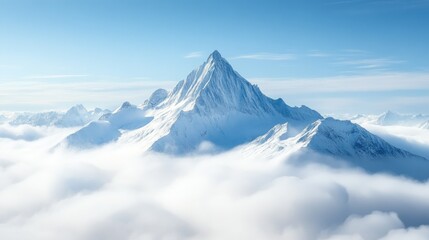 Snowy mountain peak rising above the clouds, space for copy in the crisp blue sky.