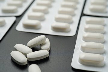 Antibiotic pills Medicine tablet capsules in blister pack on a black background