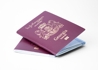 Two Georgian passports displaying the national emblem and official design against a plain background