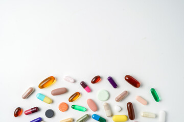 A lot of colorful medication pills capsules tablets softgel supplements, fish oil, vitamin, omega 3