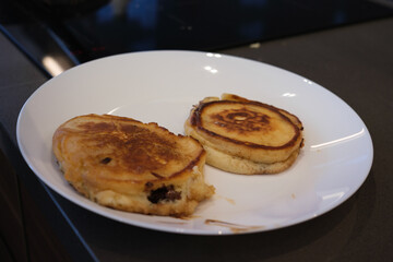 pancakes being put on white plate