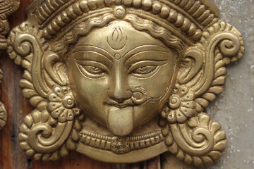 Bronze face of the Hindu goddess Kali or Durga.