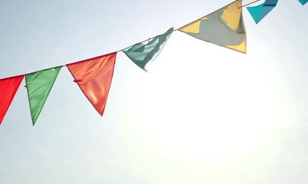 Bunting flags hanging on ropes blowing in the wind.
