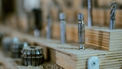 Various tools: file, screwdriver, hammer, pliers, garden tools are displayed on wooden shelf inside rustic garage or manufactory, workshop studio in a rustic garden house. Hobby, leasure activity