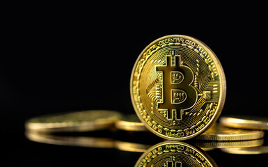 Bitcoin on dark background, Close up golden bitcoin a digital currency, operates on a decentralized system with transactions recorded and new units created without central authority