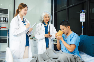 Fototapeta premium medicine, healthcare and people concept - doctor talking to male patient at bed in hospital.