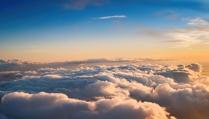 Obraz premium flight over the clouds. view of the clouds from the airplane window. sunset orange clouds at sunset