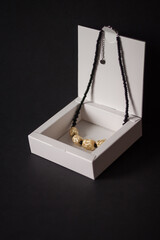 Straw necklace on a black background. Straw weaving. Small depth of field. Lutsk, Ukraine