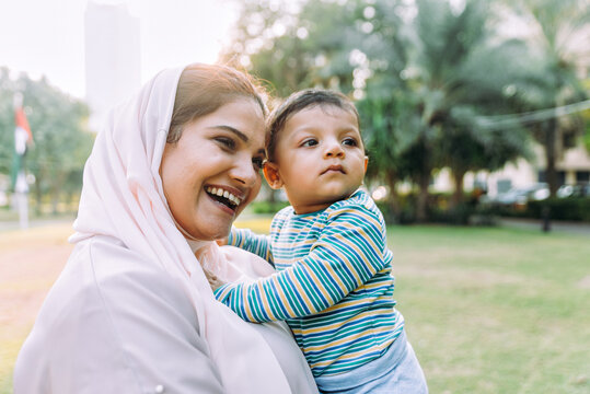 Happy lifestyle moments. Mom and his baby enjoying time in Dubai outdoor in a park.
