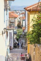 Fototapeta premium Winding through the historic streets of Nafplio, this picturesque alleyway showcases charming architecture and a glimpse of daily life, beckoning explorers to discover its hidden treasures.
