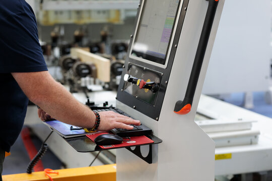 operator works at control panel of CAD CAM machine
