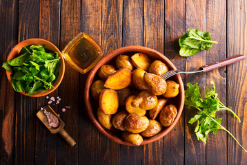 baked potato wedges with spinach on wooden table