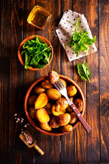 baked potato wedges with spinach on wooden table