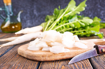 White radish on wooden board
