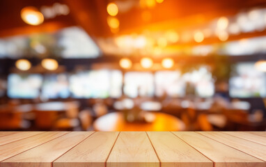 Empty wooden table top with lights bokeh on blur restaurant background.	