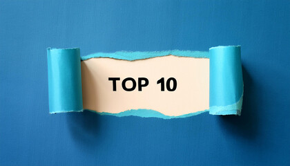 Torn paper revealing text Top 10, bright background. Business concept.