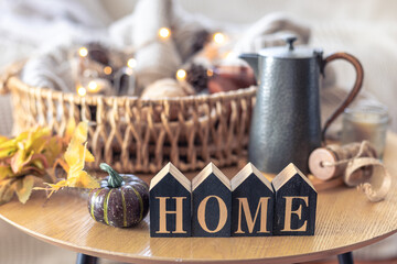 Autumn composition with the inscription home. Still life in the home interior.