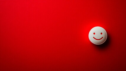 A white smiley face on a red background with copy space
