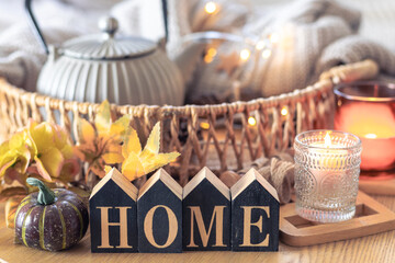 Autumn composition with the inscription home. Still life in the home interior.