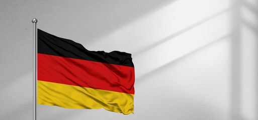 Germany  national flag cloth fabric waving on beautiful window light grey Background.