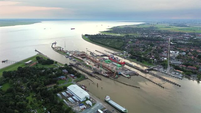 Aerial drone 4K film of the lock complex sluice and port of Brunsb&uuml;ttel under construction, the entrance of the nord ostsee kanal the Kiel canal from the north sea to the baltic across Germany with tu