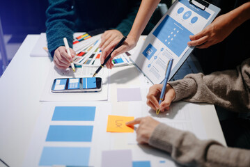  UX developer and ui designer brainstorming about mobile app interface wireframe design with...