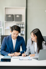 Businesswomen work and discuss their business plans. A Human employee explains and shows her colleague the results paper