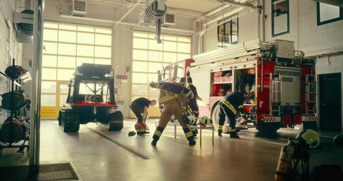 Team of Firefighters Quickly Gear up and Board a Fire Truck, Demonstrating Urgency and Readiness for an Emergency Call. Men and a Female in the Fire Station are Coordinated and Ready for the Job
