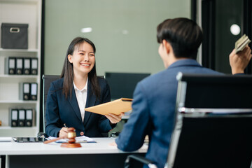 Judge gavel with scales of justice, Business and lawyer or counselor consulting and discussing contract papers with laptop and tablet at law firm
