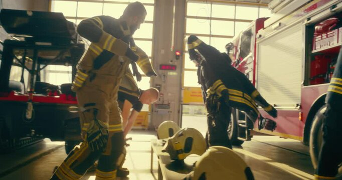 Diverse Team of Firefighters Sprint Through the Station Toward the Vehicle with Focus on a Female. They Put Their Gear with Precision, Board the Fire Truck to Handle a Critical Situation
