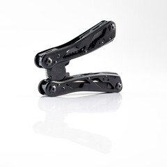 Compact portable black multitool isolated on white background. The Knife multi-tool