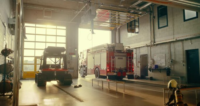 Fire Truck Moves Into Action as the Garage Door at Fire Department Opens. Vehicle with a First Response Team Pulls Out of the Station, Sirens and Lights Activated, Racing to an Emergency Call