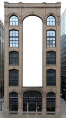 Fototapeta premium A blank billboard rests on a weathered brick building, contrasting sharply with the dark red bricks and surrounded by neighboring architecture and windows
