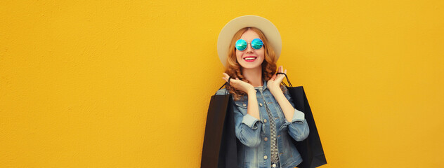 Shopping day, stylish beautiful happy smiling young woman with black shopping bags, wear summer hat