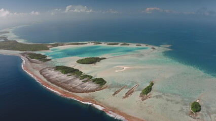 Breathtaking aerial perspective of Rangiroa island, the largest atoll in Tuamotus. Vibrant turquoise lagoon, intricate coral reefs, and abundant greenery. Remote untouched places, travel destination
