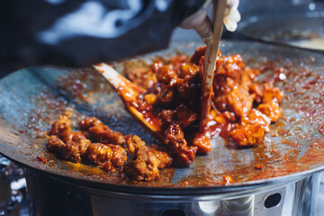Korean Street Food - Dakgangjeong, Sweet Crispy Korean Fried Chicken, variety of different traditional food selection in Seoul, South Korea, night street market with local vendor stalls cooking