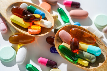 Different soft gels, Fish oil, capsules omega, vitamin pills tablets food supplements in wooden...