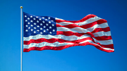 Fototapeta premium The American flag waving under a clear blue sky
