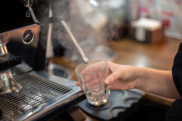 Making coffee by a barista in a coffee machine. The coffee machine makes coffee.