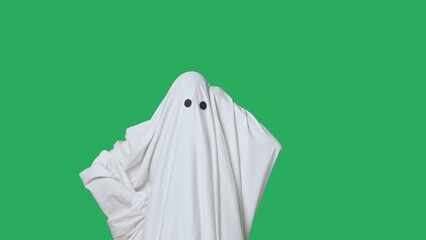 Funny halloween ghost in white sheet confused thinking, raises hand with idea, isolated on chroma...