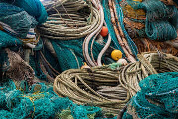 Fishing nets piled up. Various colors, patterns and textures fill the composition of the photo
