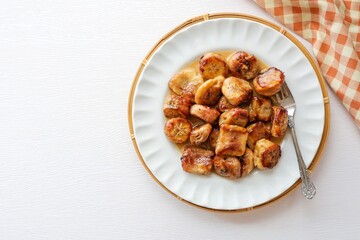 Grilled Banana with Coconut sauce on white background, top view food table	