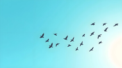 Flock of birds migrating across a clear blue sky