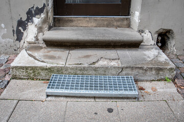Metal step at the entrance door. Urban environment