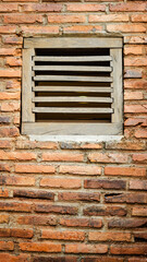 traditional wooden window in red brick wall