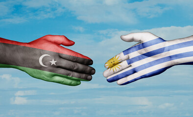 Uruguay and Libya country handshaking with flags, consensus concept international co-operation illustration