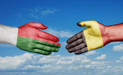 Belgium and Madagascar country handshaking with flags, consensus concept international co-operation illustration