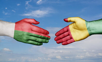 Republic of Guinea and Madagascar country handshaking with flags, consensus concept international co-operation illustration