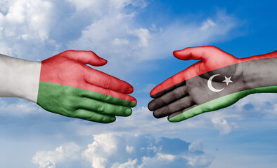 Libya and Madagascar country handshaking with flags, consensus concept international co-operation illustration